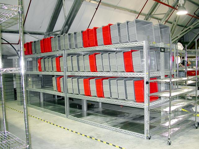 NASA image: KENNEDY SPACE CENTER, FLA.  -  Containers in the Columbia Debris Hangar are lined up after being emptied of the Columbia debris.  The debris is being transferred to storage in the Vehicle Assembly Building.  About 83,000 pieces were shipped to KSC during search and recovery efforts in East Texas.