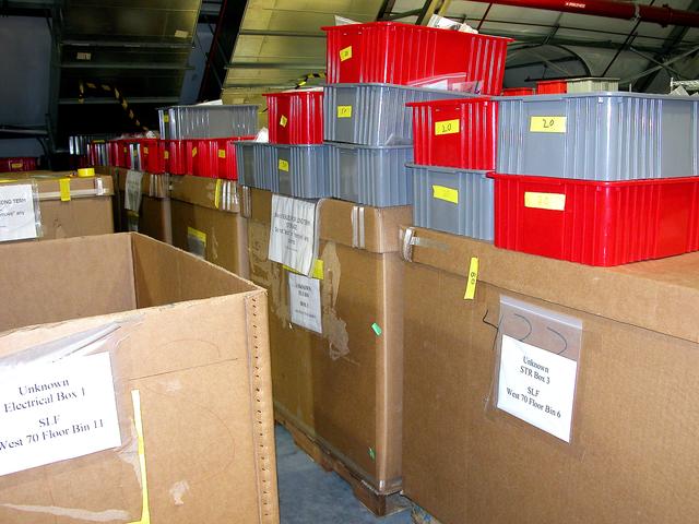 NASA image: KENNEDY SPACE CENTER, FLA.  -  Storage boxes and other containers of Columbia debris wait in the Columbia Debris Hangar for transfer to storage in the Vehicle Assembly Building.  About 83,000 pieces were shipped to KSC during search and recovery efforts in East Texas.