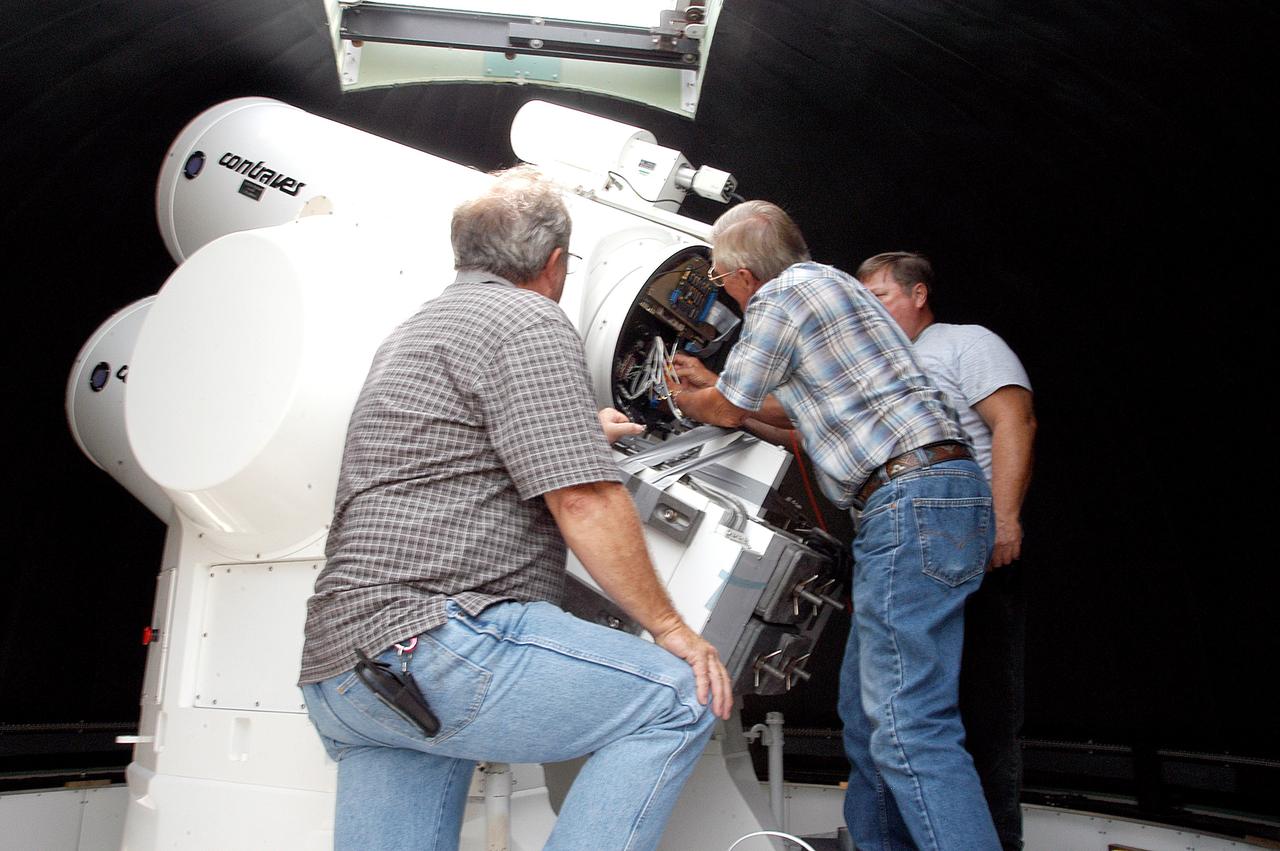 KENNEDY SPACE CENTER, FLA. -  Workers calibrate a tracking telescope, part of the Distant Object Attitude Measurement System (DOAMS),  located in Cocoa Beach, Fla.  The telescope provides optical support for launches from KSC and Cape Canaveral.