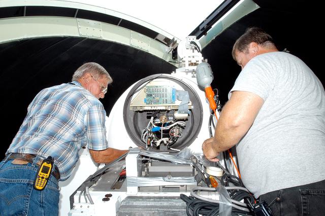 NASA image: KENNEDY SPACE CENTER, FLA. - A worker calibrates a tracking telescope, part of the Distant Object Attitude Measurement System (DOAMS),  located in Cocoa Beach, Fla.  The telescope provides optical support for launches from KSC and Cape Canaveral.