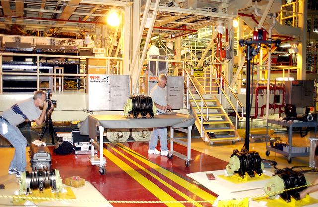 NASA image: KENNEDY SPACE CENTER, FLA. - In the Orbiter Processing Facility, an actuator is set up on a table for a 3D digital scan.  There are two actuators per engine on the Shuttle, one for pitch motion and one for yaw motion. The Space Shuttle Main Engine hydraulic servoactuators are used to gimbal the main engine.