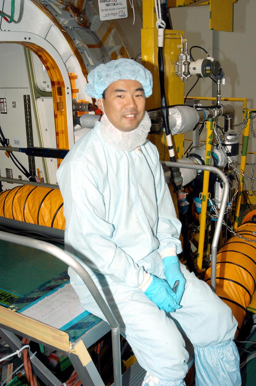 KENNEDY SPACE CENTER, FLA. -  Astronaut Soichi Noguchi, with the National Space Development Agency of Japan (NASDA), rests inside the Japanese Experiment Module (JEM), undergoing a Multi-Element Integrated Test (MEIT)  in the Space Station Processing Facility.  Noguchi is assigned to mission STS-114 as a mission specialist.   Node 2 attaches to the end of the U.S. Lab on the ISS and provides attach locations for the Japanese laboratory, European laboratory, the Centrifuge Accommodation Module and, eventually, Multipurpose Logistics Modules. It will provide the primary docking location for the Shuttle when a pressurized mating adapter is attached to Node 2.  Installation of the module will complete the U.S. Core of the ISS.   The JEM, developed by NASDA,  is Japan's primary contribution to the Station. It will enhance the unique research capabilities of the orbiting complex by providing an additional environment for astronauts to conduct science experiments.