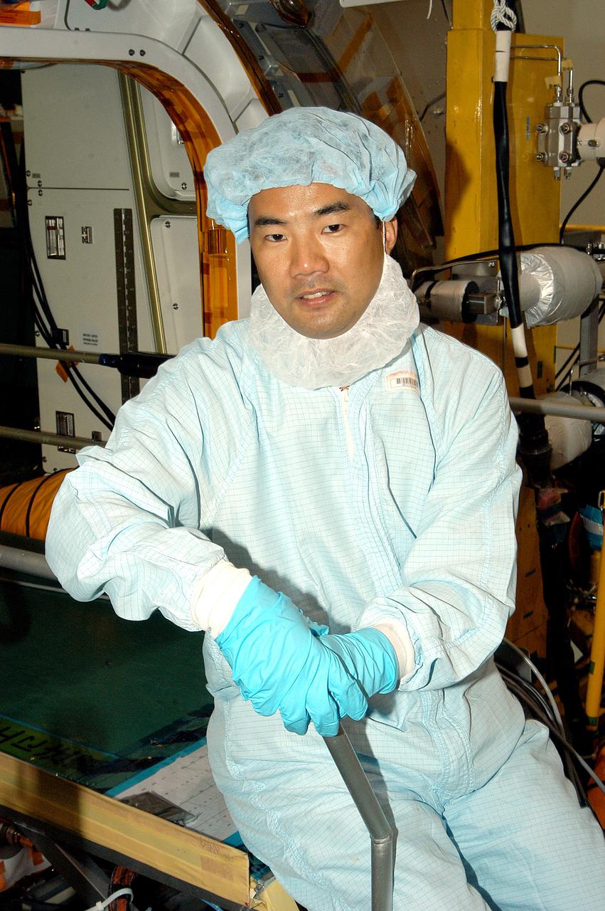 KENNEDY SPACE CENTER, FLA. -  Astronaut Soichi Noguchi, with the National Space Development Agency of Japan (NASDA), rests inside the Japanese Experiment Module (JEM), undergoing a Multi-Element Integrated Test (MEIT)  in the Space Station Processing Facility.  Noguchi is assigned to mission STS-114 as a mission specialist.   Node 2 attaches to the end of the U.S. Lab on the ISS and provides attach locations for the Japanese laboratory, European laboratory, the Centrifuge Accommodation Module and, eventually, Multipurpose Logistics Modules. It will provide the primary docking location for the Shuttle when a pressurized mating adapter is attached to Node 2.  Installation of the module will complete the U.S. Core of the ISS.   The JEM, developed by NASDA,  is Japan's primary contribution to the Station. It will enhance the unique research capabilities of the orbiting complex by providing an additional environment for astronauts to conduct science experiments.