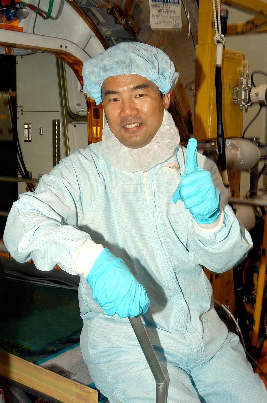 KENNEDY SPACE CENTER, FLA. -  Astronaut Soichi Noguchi, with the National Space Development Agency of Japan (NASDA), signals success during a Multi-Element Integrated Test (MEIT ) of the Japanese Experiment Module (JEM) in the Space Station Processing Facility.  Noguchi is assigned to mission STS-114 as a mission specialist.   Node 2 attaches to the end of the U.S. Lab on the ISS and provides attach locations for the Japanese laboratory, European laboratory, the Centrifuge Accommodation Module and, eventually, Multipurpose Logistics Modules. It will provide the primary docking location for the Shuttle when a pressurized mating adapter is attached to Node 2.  Installation of the module will complete the U.S. Core of the ISS.   The JEM, developed by NASDA,  is Japan's primary contribution to the Station. It will enhance the unique research capabilities of the orbiting complex by providing an additional environment for astronauts to conduct science experiments.