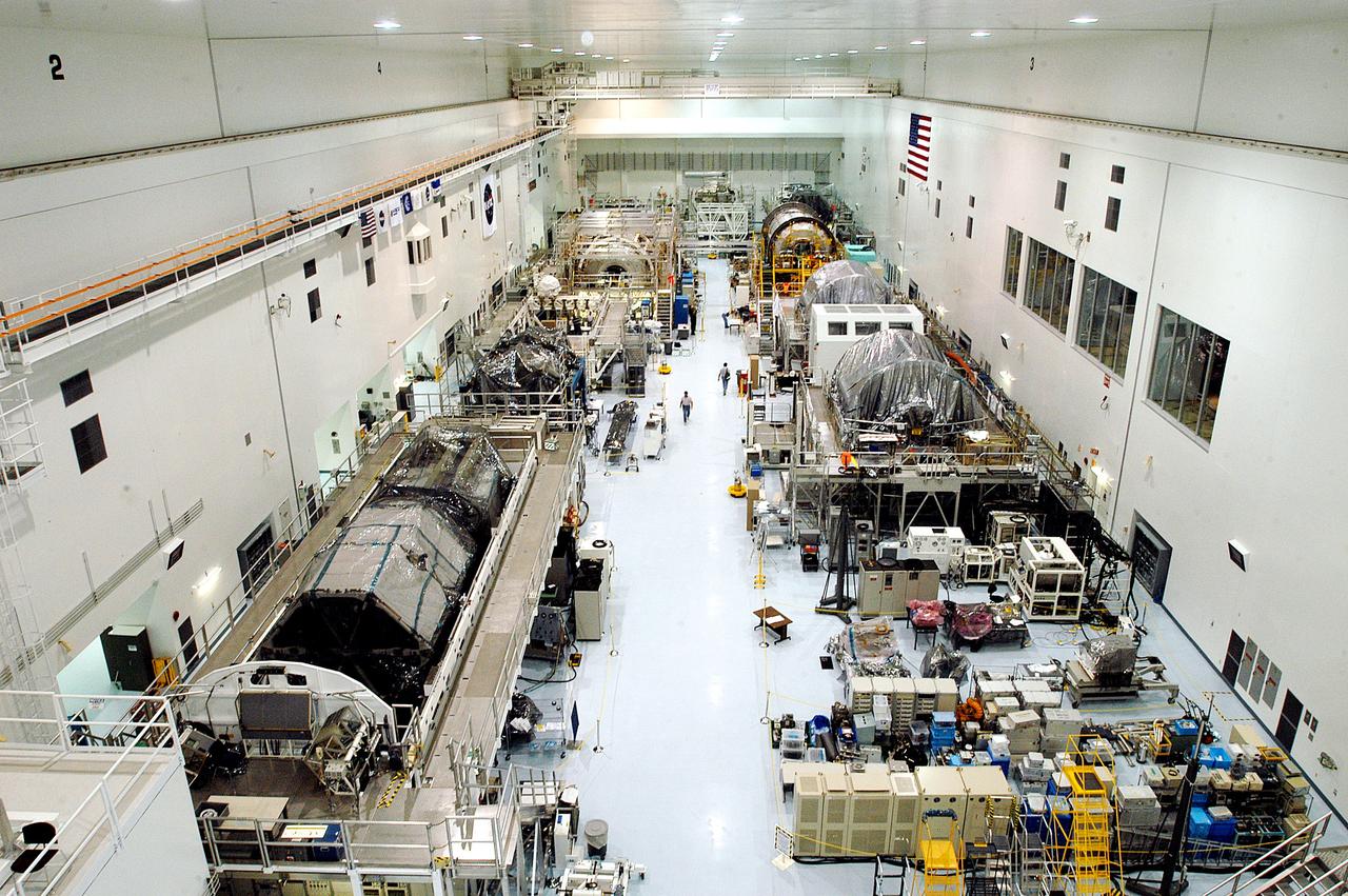 KENNEDY SPACE CENTER, FLA. -  Various elements intended for the International Space Station are lined up in the Space Station Processing Facility.  The newest to arrive at KSC are in the rear: at left, the U.S. Node 2, and next to it at right, the Japanese Experiment Module (JEM).  The two elements are undergoing a Multi-Element Integrated Test (MEIT).   Node 2 attaches to the end of the U.S. Lab on the ISS and provides attach locations for the Japanese laboratory, European laboratory, the Centrifuge Accommodation Module and, eventually, Multipurpose Logistics Modules. It will provide the primary docking location for the Shuttle when a pressurized mating adapter is attached to Node 2.  Installation of the module will complete the U.S. Core of the ISS.   Developed by the National Space Development Agency of Japan (NASDA), the JEM is Japan's primary contribution to the Station. It will enhance the unique research capabilities of the orbiting complex by providing an additional environment for astronauts to conduct science experiments.
