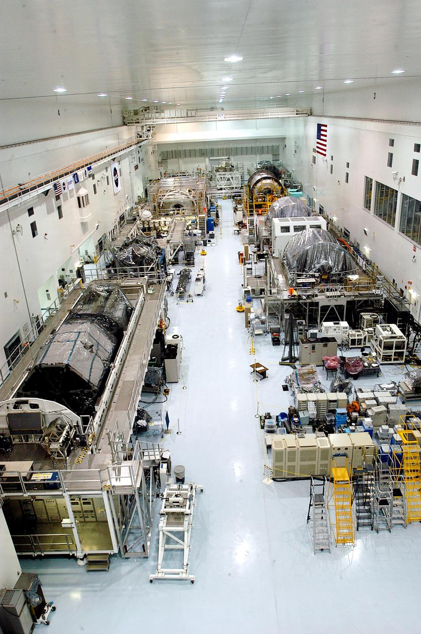 KENNEDY SPACE CENTER, FLA. -  Various elements intended for the International Space Station are lined up in the Space Station Processing Facility.  The newest to arrive at KSC are in the rear: at left, the U.S. Node 2, and next to it at right, the Japanese Experiment Module (JEM).  The two elements are undergoing a Multi-Element Integrated Test (MEIT).   Node 2 attaches to the end of the U.S. Lab on the ISS and provides attach locations for the Japanese laboratory, European laboratory, the Centrifuge Accommodation Module and, eventually, Multipurpose Logistics Modules. It will provide the primary docking location for the Shuttle when a pressurized mating adapter is attached to Node 2.  Installation of the module will complete the U.S. Core of the ISS.   Developed by the National Space Development Agency of Japan (NASDA), the JEM is Japan's primary contribution to the Station. It will enhance the unique research capabilities of the orbiting complex by providing an additional environment for astronauts to conduct science experiments.