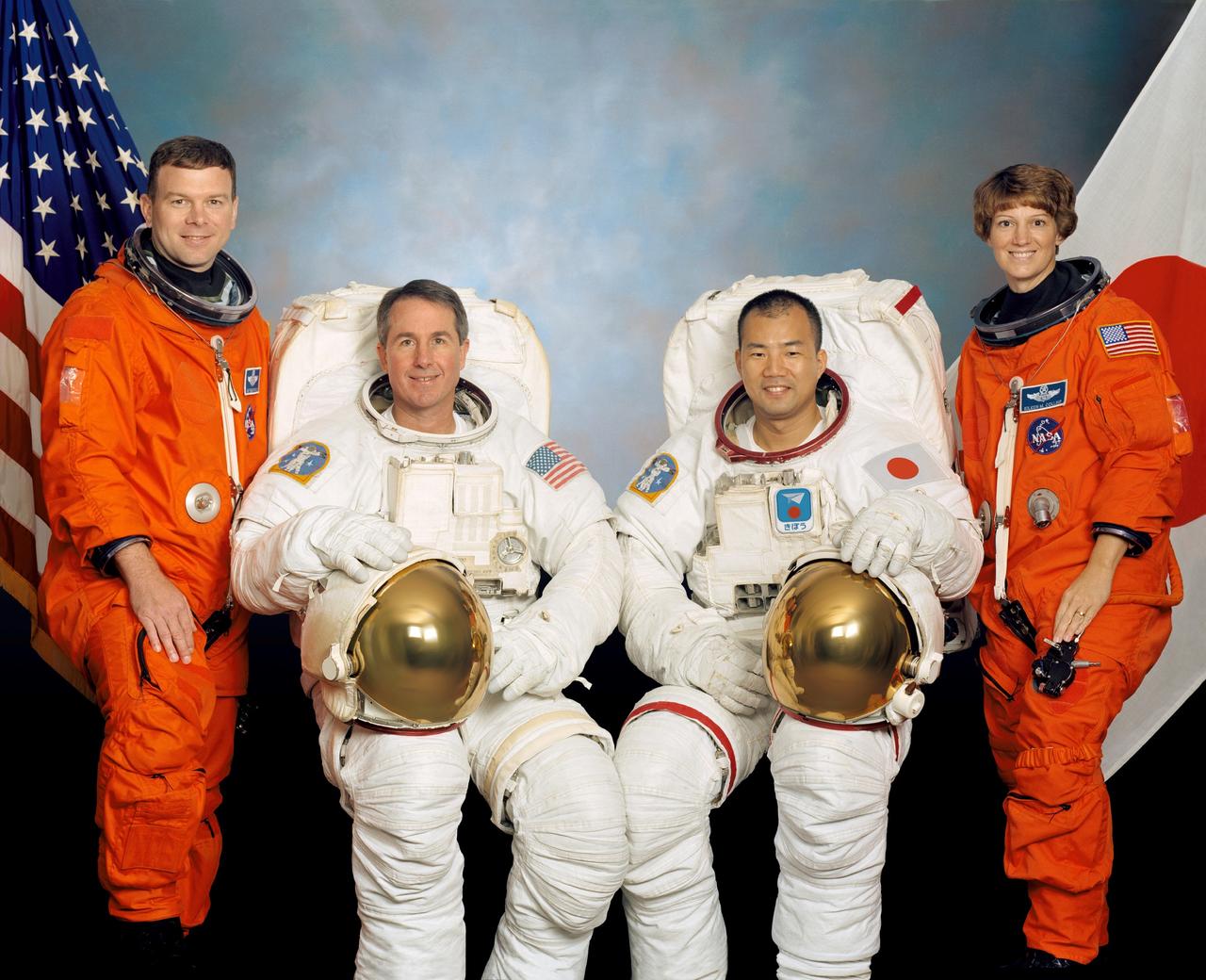 JOHNSON SPACE CENTER, HOUSTON, TEXAS -- (STS114-S-002) -- These four astronauts are in training for the STS-114 mission. Astronauts Eileen M. Collins, mission commander, and James M. Kelly, pilot, flank the two mission specialists -- astronauts Stephen K. Robinson (second from left) and Soichi Noguchi -- who are assigned to spacewalk duty to perform work on the International Space Station. Noguchi represents the Japanese Space agency.