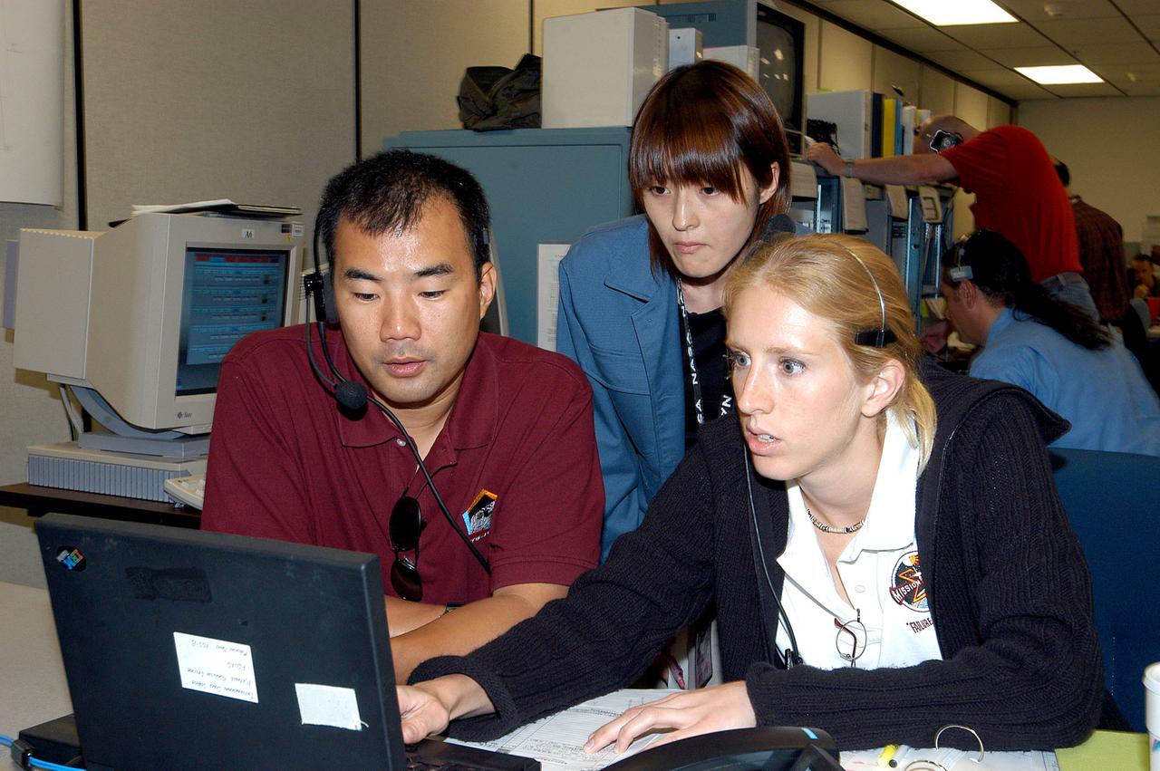 KENNEDY SPACE CENTER, FLA. -  Astronaut Soichi Noguchi (left), with the National Space Development Agency of Japan (NASDA), works at a console during a Multi-Element Integrated Test (MEIT) of the U.S. Node 2 and the Japanese Experiment Module (JEM) in the Space Station Processing Facility.  The JEM, developed by NASDA, is Japan's primary contribution to the Station. It will enhance the unique research capabilities of the orbiting complex by providing an additional environment for astronauts to conduct science experiments. Noguchi is assigned to mission STS-114 as a mission specialist.  Node 2 provides attach locations for the Japanese laboratory, as well as European laboratory, the Centrifuge Accommodation Module and, eventually, Multipurpose Logistics Modules.  Installation of the module will complete the U.S. Core of the ISS.