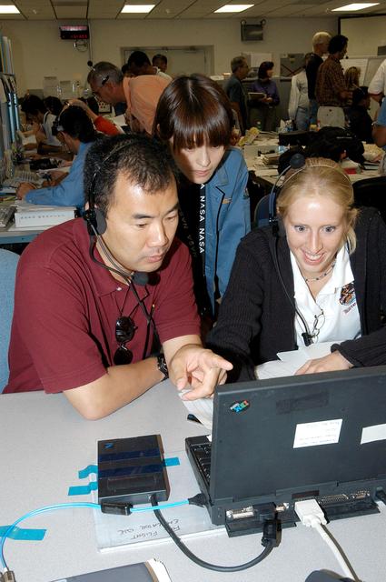NASA image: KENNEDY SPACE CENTER, FLA. -  Astronaut Soichi Noguchi (left), with the National Space Development Agency of Japan (NASDA), points to data on the console during a Multi-Element Integrated Test (MEIT) of the U.S. Node 2 and the Japanese Experiment Module (JEM) in the Space Station Processing Facility.  The JEM, developed by NASDA, is Japan's primary contribution to the Station. It will enhance the unique research capabilities of the orbiting complex by providing an additional environment for astronauts to conduct science experiments. Noguchi is assigned to mission STS-114 as a mission specialist.  Node 2 provides attach locations for the Japanese laboratory, as well as European laboratory, the Centrifuge Accommodation Module and, eventually, Multipurpose Logistics Modules.  Installation of the module will complete the U.S. Core of the ISS.