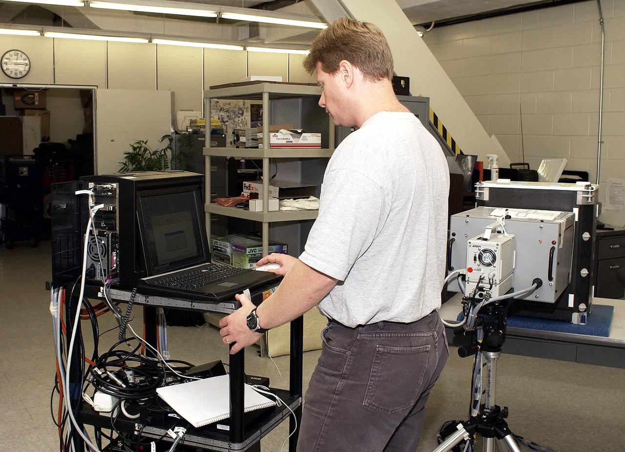 KENNEDY SPACE CENTER, FLA. - In the Vehicle Assembly Building, Jim Landy, NDE specialist, performs flash thermography on flight crew lockers. He is screening the lockers for hidden damage underneath dings and dents that might occur during handling.