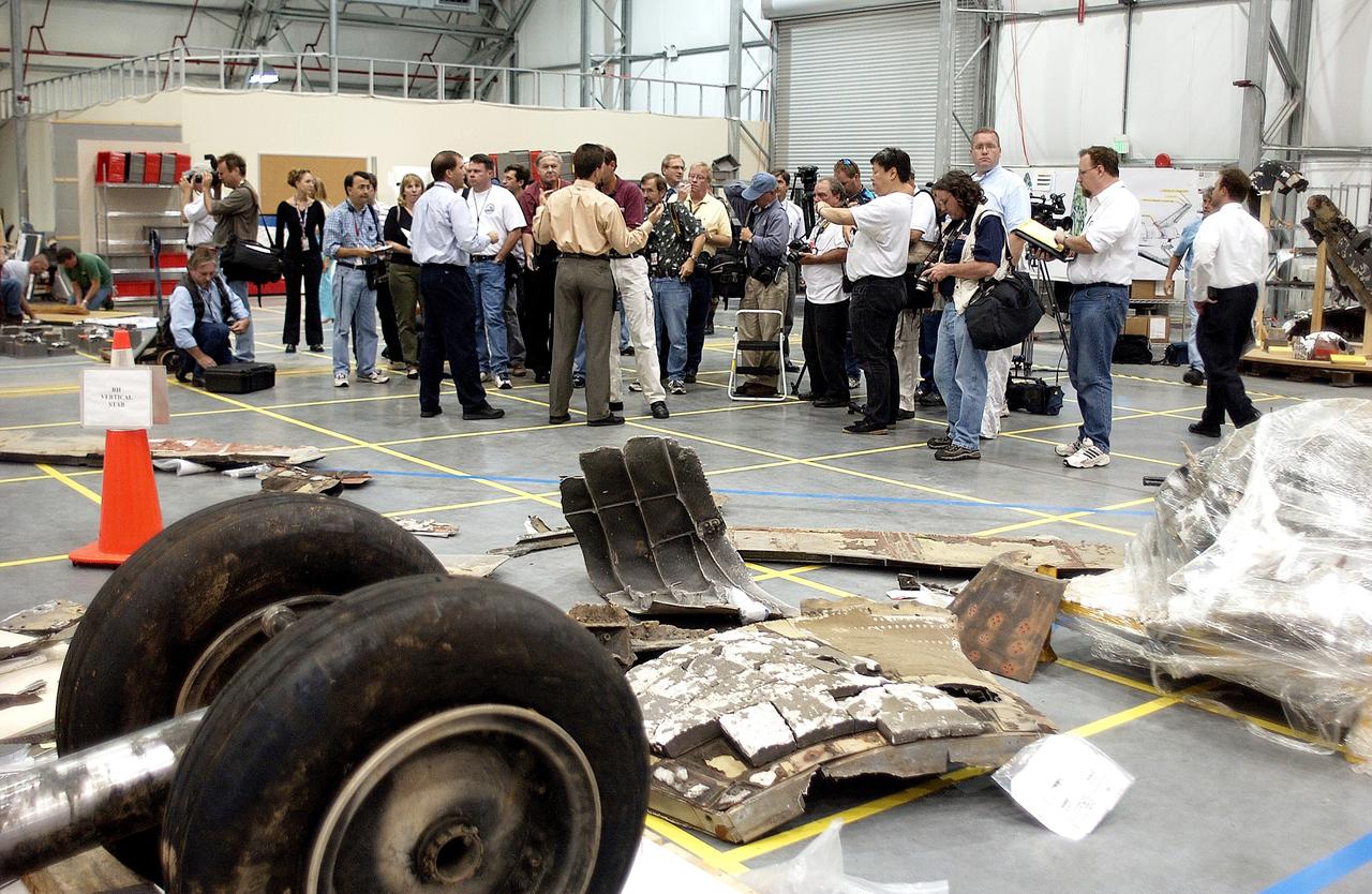 KENNEDY SPACE CENTER, FLA. - The media listen to Scott Thurston, NASA vehicle flow manager, talk about efforts to pack the debris stored in the Columbia Debris Hangar.  More than 83,000  pieces of debris were shipped to KSC during search and recovery efforts in East Texas. That represents about 38 percent of the dry weight of Columbia, equaling almost 85,000 pounds. An area of the Vehicle Assembly Building is being prepared to store the debris permanently.