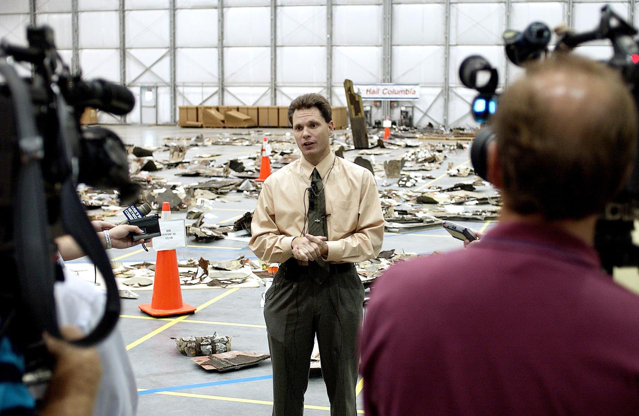 KENNEDY SPACE CENTER, FLA. - In the Columbia Debris Hangar, Scott Thurston, NASA vehicle flow manager, addresses the media about efforts to pack the debris stored in the Columbia Debris Hangar.  More than 83,000  pieces of debris were shipped to KSC during search and recovery efforts in East Texas. That represents about 38 percent of the dry weight of Columbia, equaling almost 85,000 pounds. An area of the Vehicle Assembly Building is being prepared to store the debris permanently.