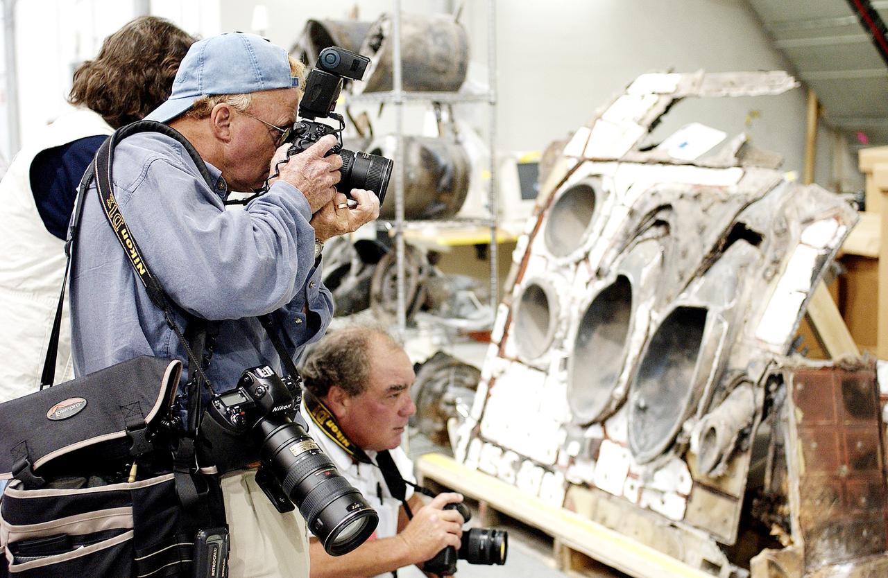 KENNEDY SPACE CENTER, FLA. - During a media tour of the Columbia Debris Hangar, photographers focus on a piece of the debris collected from search and recovery efforts in East Texas. About 83,000 pieces of debris from Columbia were shipped to KSC, which represents about 38 percent of the dry weight of Columbia, equaling almost 85,000 pounds.  The debris is being packaged for storage in an area of the Vehicle Assembly Building.