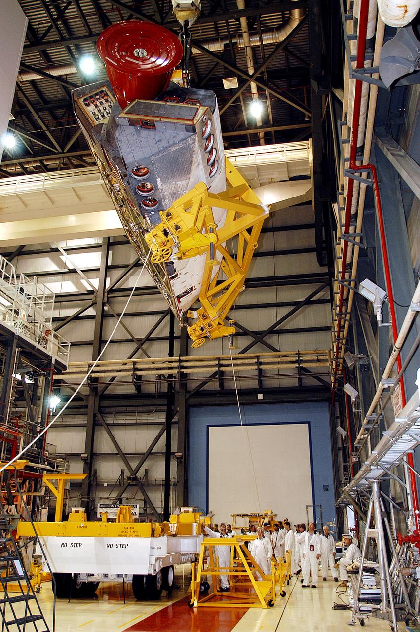 KENNEDY SPACE CENTER, FLA. - In the Orbiter Processing Facility, one of two orbital maneuvering system (OMS) pods removed from Endeavour is suspended overhead. The OMS pods are attached to the upper aft fuselage left and right sides. Fabricated primarily of graphite epoxy composite and aluminum, each pod is 21.8 feet long and 11.37 feet wide at its aft end and 8.41 feet wide at its forward end, with a surface area of approximately 435 square feet. Each pod houses the Reaction Control System propulsion components used for inflight maneuvering and is attached to the aft fuselage with 11 bolts. OMS pods are removed during Orbiter Major Modifications. Once removed, the OMS pods undergo in-depth structural inspections, system checks and the thrusters are changed out.