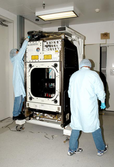 NASA image: KENNEDY SPACE CENTER, FLA. -   Workers in the Space Station Processing Facility check out the Window Observational Research Facility (WORF),  designed and built by the Boeing Co. at NASA’s Marshall Space Flight Center in Huntsville, Ala.   WORF will be delivered to the International Space Station and placed in the rack position in front of the Destiny lab window,  providing locations for attaching cameras, multi-spectral scanners and other instruments. WORF will support a variety of scientific and commercial experiments in areas of Earth systems and processes, global ecological changes in Earth’s biosphere, lithosphere, hydrosphere and climate system, Earth resources, natural hazards, and education.  After installation, it will become a permanent focal point for Earth Science research aboard the space station.