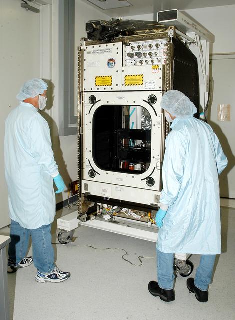 NASA image: KENNEDY SPACE CENTER, FLA. -  Workers in the Space Station Processing Facility check out the Window Observational Research Facility (WORF),  designed and built by the Boeing Co. at NASA’s Marshall Space Flight Center in Huntsville, Ala.   WORF will be delivered to the International Space Station and placed in the rack position in front of the Destiny lab window,  providing locations for attaching cameras, multi-spectral scanners and other instruments. WORF will support a variety of scientific and commercial experiments in areas of Earth systems and processes, global ecological changes in Earth’s biosphere, lithosphere, hydrosphere and climate system, Earth resources, natural hazards, and education.  After installation, it will become a permanent focal point for Earth Science research aboard the space station.