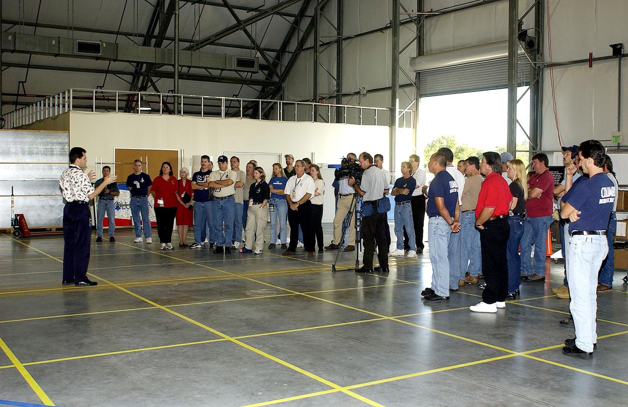 KENNEDY SPACE CENTER, FLA. -  Scott Thurston, NASA vehicle flow manager, speaks to members of the Columbia Reconstruction Team during transfer of debris from the Columbia Debris Hangar to its permanent storage site in the Vehicle Assembly Building.  More than 83,000 pieces of debris were shipped to KSC during search and recovery efforts in East Texas. That represents about 38 percent of the dry weight of Columbia, equaling almost 85,000 pounds.