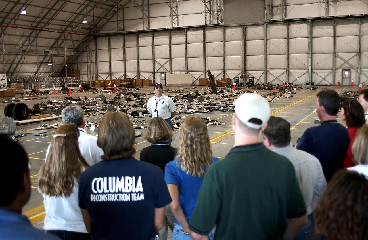 KENNEDY SPACE CENTER, FLA. -  Jim Comer, United Space Alliance project leader for Columbia reconstruction, speaks to members of the Columbia Reconstruction Team during transfer of debris from the Columbia Debris Hangar to its permanent storage site in the Vehicle Assembly Building.  More than 83,000 pieces of debris were shipped to KSC during search and recovery efforts in East Texas. That represents about 38 percent of the dry weight of Columbia, equaling almost 85,000 pounds.