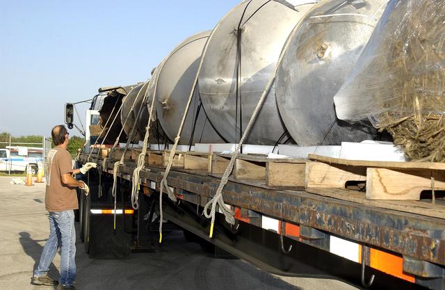 NASA image: KENNEDY SPACE CENTER, FLA. -  At the Columbia Debris Hangar, some of the debris of Space Shuttle Columbia is secured onto a flatbed truck for transfer to the Vehicle Assembly Building for permanent storage.  More than 83,000  pieces of debris were shipped to KSC during search and recovery efforts in East Texas. That represents about 38 percent of the dry weight of Columbia, equaling almost 85,000 pounds.