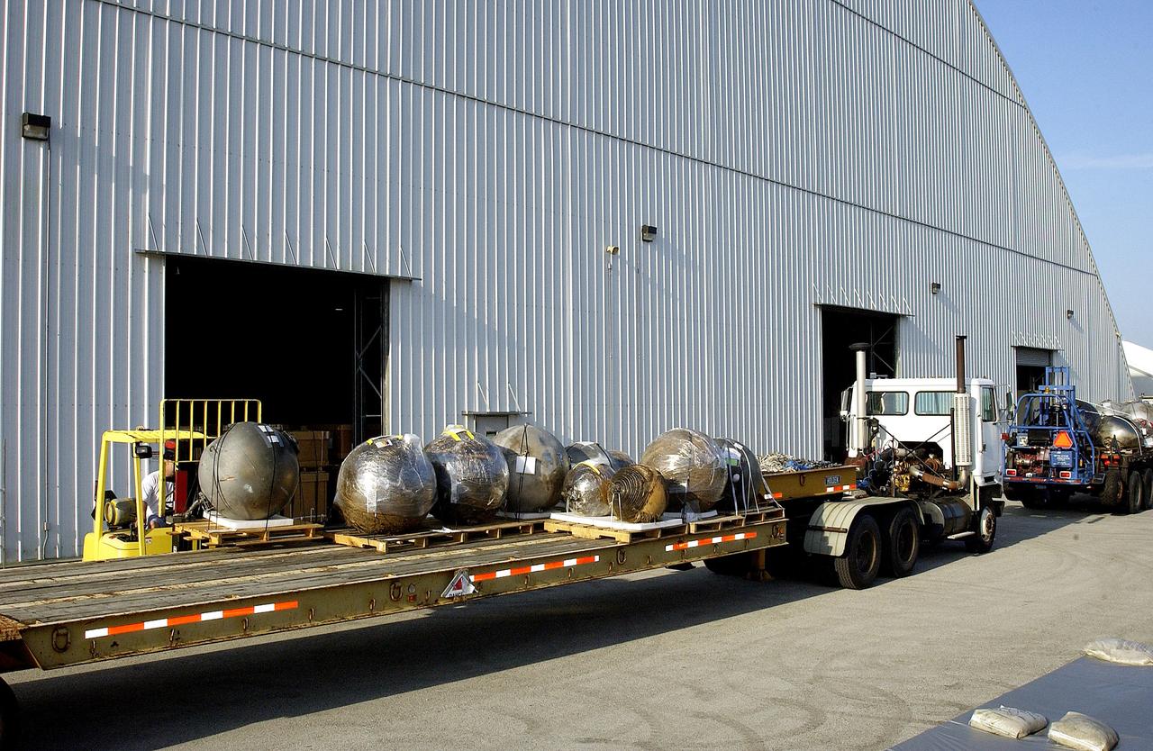 KENNEDY SPACE CENTER, FLA. -  At the Columbia Debris Hangar, some of the debris of Space Shuttle Columbia is moved onto a flatbed truck for transfer to the Vehicle Assembly Building for permanent storage.  More than 83,000 pieces of debris were shipped to KSC during search and recovery efforts in East Texas. That represents about 38 percent of the dry weight of Columbia, equaling almost 85,000 pounds.