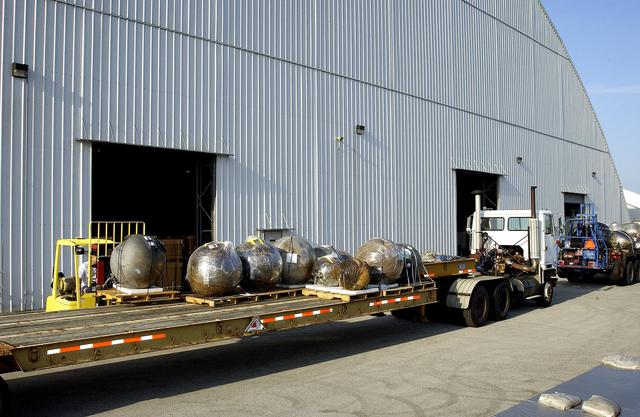 NASA image: KENNEDY SPACE CENTER, FLA. -  At the Columbia Debris Hangar, some of the debris of Space Shuttle Columbia is moved onto a flatbed truck for transfer to the Vehicle Assembly Building for permanent storage.  More than 83,000 pieces of debris were shipped to KSC during search and recovery efforts in East Texas. That represents about 38 percent of the dry weight of Columbia, equaling almost 85,000 pounds.
