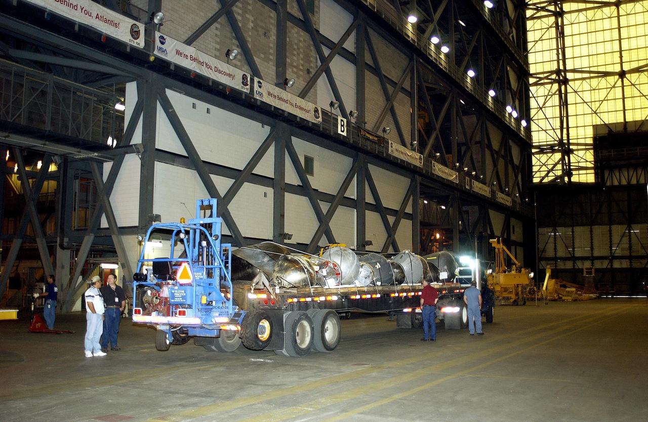 KENNEDY SPACE CENTER, FLA.  -  A flatbed truck carrying pieces of Columbia debris  arrives in the transfer aisle of the Vehicle Assembly Building.  The debris is being transferred to the VAB for permanent storage.  More than 83,000  pieces of debris were shipped to KSC during search and recovery efforts in East Texas. That represents about 38 percent of the dry weight of Columbia, equaling almost 85,000 pounds.