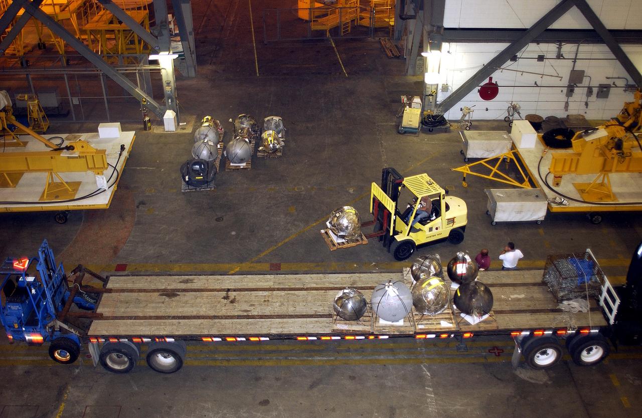 KENNEDY SPACE CENTER, FLA. -  Pieces of debris of Space Shuttle Columbia are offloaded from a flatbed truck in the transfer aisle of the Vehicle Assembly Building (VAB).  The debris is being moved from the Columbia Debris Hangar to the VAB for permanent storage.  More than 83,000 pieces of debris were shipped to KSC during search and recovery efforts in East Texas. That represents about 38 percent of the dry weight of Columbia, equaling almost 85,000 pounds.
