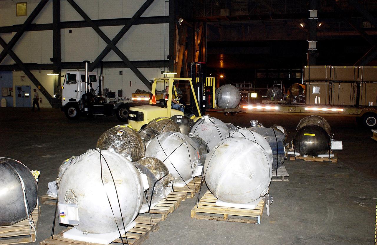 KENNEDY SPACE CENTER, FLA. -  Pieces of debris of Space Shuttle Columbia are offloaded from a flatbed truck in the transfer aisle of the Vehicle Assembly Building (VAB).  The debris is being moved from the Columbia Debris Hangar to the VAB for permanent storage.  More than 83,000 pieces of debris were shipped to KSC during search and recovery efforts in East Texas. That represents about 38 percent of the dry weight of Columbia, equaling almost 85,000 pounds.