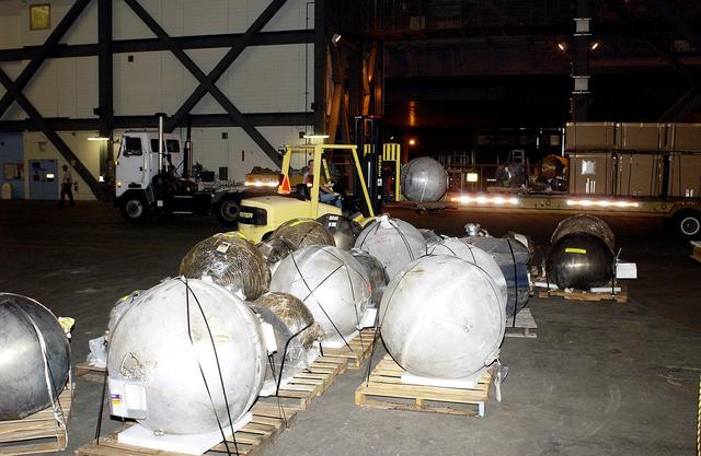 NASA image: KENNEDY SPACE CENTER, FLA. -  Pieces of debris of Space Shuttle Columbia are offloaded from a flatbed truck in the transfer aisle of the Vehicle Assembly Building (VAB).  The debris is being moved from the Columbia Debris Hangar to the VAB for permanent storage.  More than 83,000 pieces of debris were shipped to KSC during search and recovery efforts in East Texas. That represents about 38 percent of the dry weight of Columbia, equaling almost 85,000 pounds.