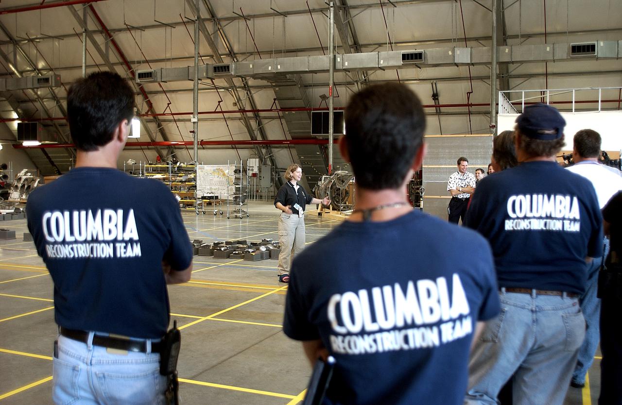 KENNEDY SPACE CENTER, FLA. -  Astronaut Pam Melroy speaks to members of the Columbia Reconstruction Team during transfer of debris from the Columbia Debris Hangar to its permanent storage site in the Vehicle Assembly Building.  More than 83,000 pieces of debris were shipped to KSC during search and recovery efforts in East Texas. That represents about 38 percent of the dry weight of Columbia, equaling almost 85,000 pounds.