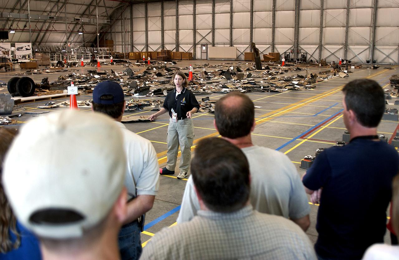 KENNEDY SPACE CENTER, FLA.  -  Astronaut Pam Melroy speaks to members of the Columbia Reconstruction Team during transfer of debris from the Columbia Debris Hangar to  its permanent storage site in the Vehicle Assembly Building.  More than 83,000  pieces of debris were shipped to KSC during search and recovery efforts in East Texas. That represents about 38 percent of the dry weight of Columbia, equaling almost 85,000 pounds.
