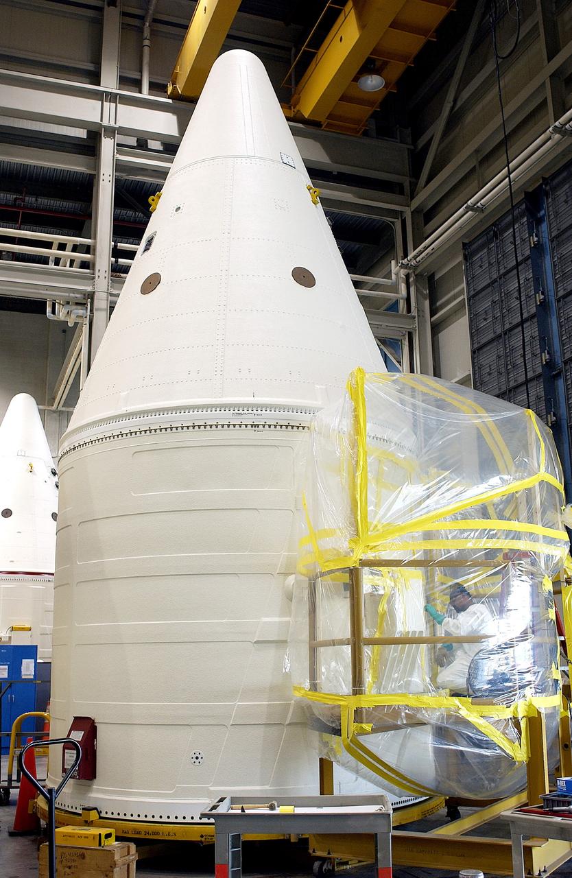 KENNEDY SPACE CENTER, FLA. - In the Solid Rocket Booster Assembly and Refurbishment Facility (ARF), Vernon Gibbs, with United Space Alliance, prepares the forward skirt of a solid rocket booster for installation of the parachute camera.  Refurbishment and subassembly of Shuttle SRB hardware - primarily the forward and aft assemblies - is carried out in the ARF.