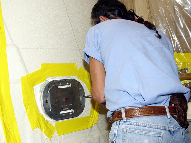 NASA image: KENNEDY SPACE CENTER, FLA. -  In the Solid Rocket Booster Assembly and Refurbishment Facility (ARF), Donnie Cardigan, with United Space Alliance,  installs the parachute camera on the solid rocket booster forward skirt.  Refurbishment and subassembly of Shuttle SRB hardware - primarily the forward and aft assemblies - is carried out in the ARF.