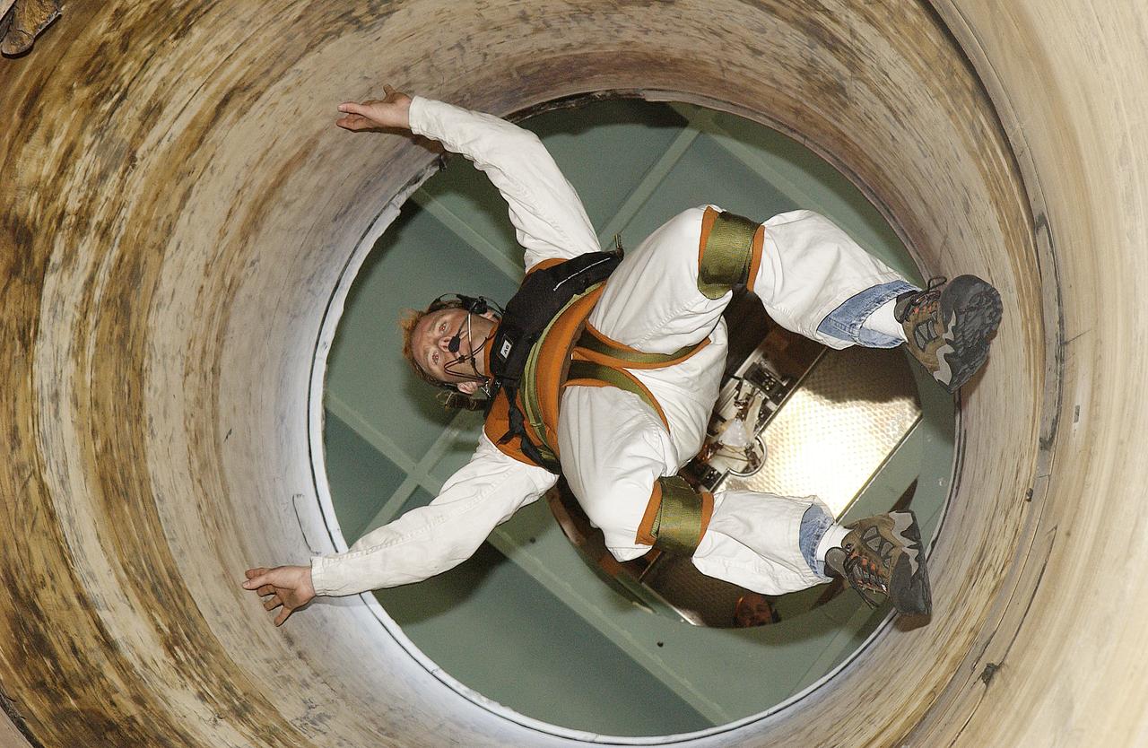 Jeff Thon, an SRB mechanic with United Space Alliance, is lowered into a mockup of a segment of a solid rocket booster. He is testing a technique for vertical SRB propellant grain inspection. The inspection of segments is required as part of safety analysis.