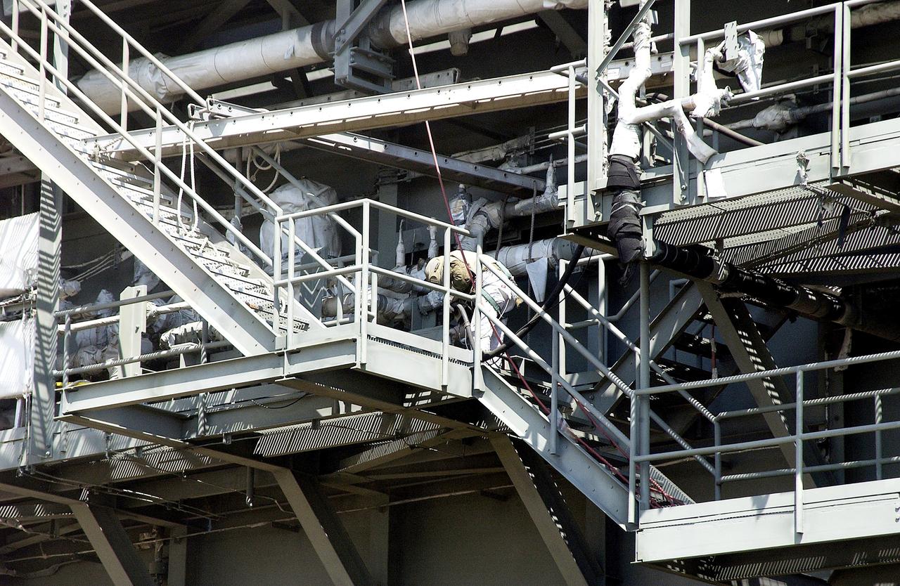 KENNEDY SPACE CENTER, FLA. - Workers, covered in protective clothing and breathing apparatus, continue sandblasting on the Mobile Launcher Platform on Launch Pad 39A to remove corrosion before repainting.  Routine maintenance includes sandblasting and repainting as preventive means to minimize corrosion.