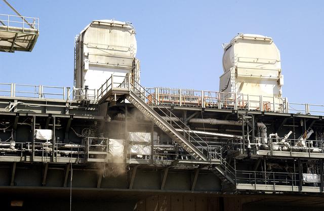 NASA image: KENNEDY SPACE CENTER, FLA. -  On Launch Pad 39A, clouds of dust float away from the Mobile Launcher Platform, which is undergoing sandblasting to remove corrosion before repainting.  Routine maintenance includes sandblasting and repainting as preventive means to minimize corrosion.