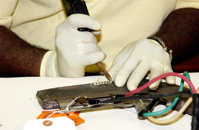 NASA image: KENNEDY SPACE CENTER, FLA. -  United Space Alliance employee Anthony Simmons electrowelds a crack formed in the insulator inside a Reinforced Carbon Carbon panel.   The gray carbon composite RCC panels are attached to the leading edge of the wing of the orbiters to withstand the aerodynamic forces experienced during launch and reentry, which can reach as high as 800 pounds per square foot.  The operating range of RCC is from minus 250º F to about 3,000º F, the temperature produced by friction with the atmosphere during reentry.