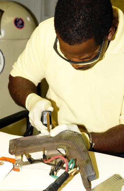 NASA image: KENNEDY SPACE CENTER, FLA. -   United Space Alliance employee Anthony Simmons continues electrowelding on an insulator inside a Reinforced Carbon Carbon panel.   The gray carbon composite RCC panels are attached to the leading edge of the wing of the orbiters to withstand the aerodynamic forces experienced during launch and reentry, which can reach as high as 800 pounds per square foot.  The operating range of RCC is from minus 250º F to about 3,000º F, the temperature produced by friction with the atmosphere during reentry.