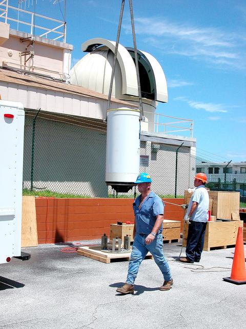 NASA image: KENNEDY SPACE CENTER, FLA. -  In Cocoa Beach, Fla., a new five-meter telescope is lifted up to the dome for installation.  The tracking telescope is part of the Distant Object Attitude Measurement System (DOAMS) that provides optical support for launches from KSC and Cape Canaveral.