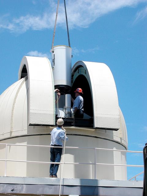 NASA image: KENNEDY SPACE CENTER, FLA. - In Cocoa Beach, Fla., a new five-meter telescope is lowered into the dome for installation.  The tracking telescope is part of the Distant Object Attitude Measurement System (DOAMS) that provides optical support for launches from KSC and Cape Canaveral.