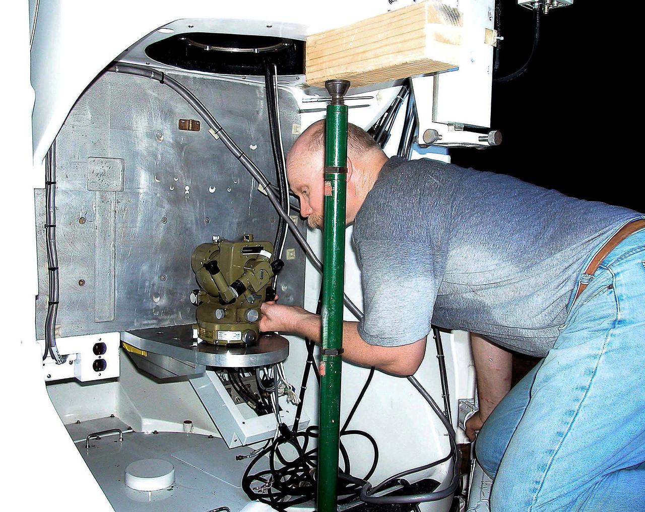 KENNEDY SPACE CENTER, FLA. -  A worker calibrates the thermolite level on a newly installed five-meter focal length telescope in Cocoa Beach, Fla.  The tracking telescope is part of the Distant Object Attitude Measurement System (DOAMS) that provides optical support for launches from KSC and Cape Canaveral.