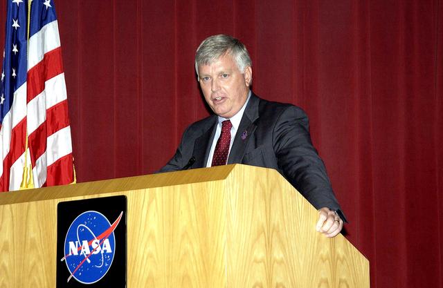 NASA image: KENNEDY SPACE CENTER, FLA. -  Center Director Jim Kennedy talks to employees during his first all-hands meeting.  Making presentations were Dr. Woodrow Whitlow Jr., KSC deputy director,; Tim Wilson, assistant chief engineer for Shuttle; and Bill Pickavance, vice president and deputy program manager, Florida operations, United Space Alliance.  Representatives from the Shuttle program and contractor team were on hand to discuss the Columbia Accident Investigation Board report and where KSC stands in its progress toward return to flight.