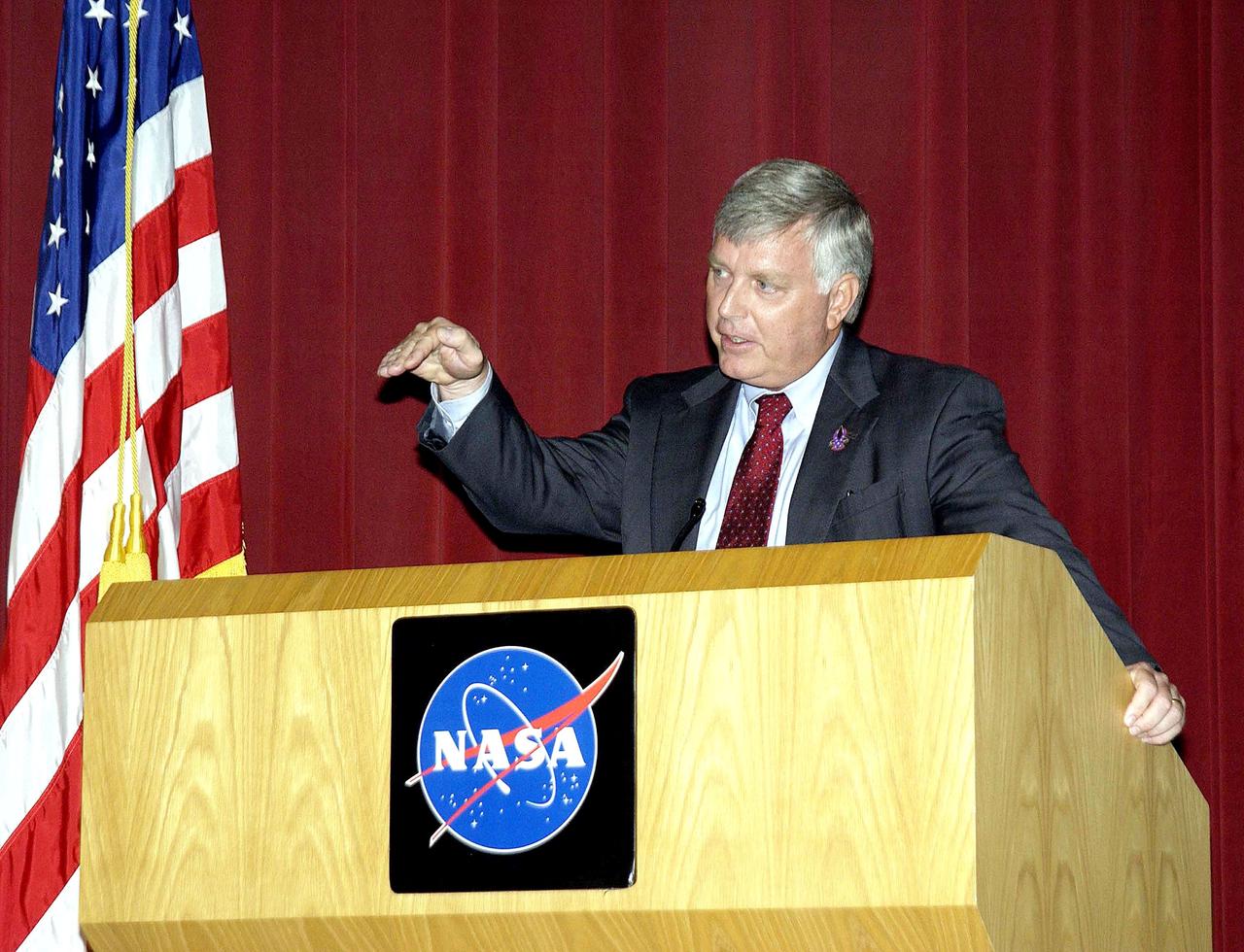 KENNEDY SPACE CENTER, FLA. -  Center Director Jim Kennedy talks to employees during his first all-hands meeting. Making presentations were Dr. Woodrow Whitlow Jr., KSC deputy director;Tim Wilson, assistant chief engineer for Shuttle; and Bill Pickavance, vice president and deputy program manager, Florida operations, United Space Alliance..  Representatives from the Shuttle program and contractor team were on hand to discuss the Columbia Accident Investigation Board report and where KSC stands in its progress toward return to flight.