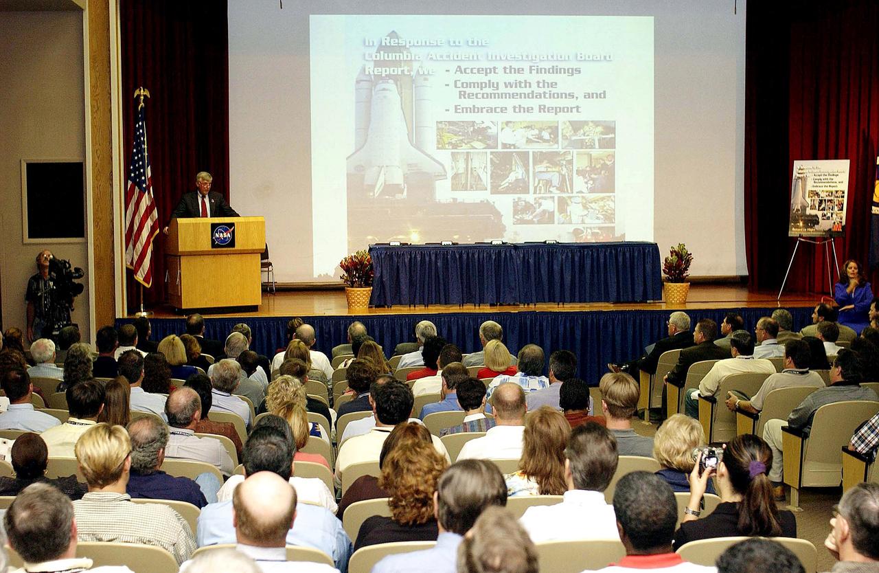 KENNEDY SPACE CENTER, FLA. -  Center Director Jim Kennedy talks to employees during his first all-hands meeting. Making presentations were Dr. Woodrow Whitlow Jr., KSC deputy director; Tim Wilson, assistant chief engineer for Shuttle; and Bill Pickavance, vice president and deputy program manager, Florida operations, United Space Alliance.  Representatives from the Shuttle program and contractor team were on hand to discuss the Columbia Accident Investigation Board report and where KSC stands in its progress toward return to flight.