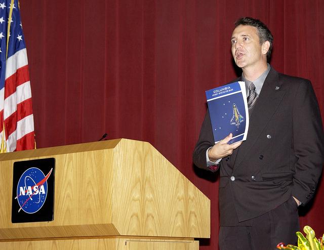 NASA image: KENNEDY SPACE CENTER, FLA. -  Tim Wilson, assistant chief engineer for Shuttle,  speaks to employees during Center Director Jim Kennedy’s first all-hands meeting for employees.  Also on the agenda was Dr. Woodrow Whitlow Jr., KSC deputy director, and Bill Pickavance, vice president and deputy program manager, Florida operations, United Space Alliance.  Representatives from the Shuttle program and contractor team were on hand to discuss the Columbia Accident Investigation Board report and where KSC stands in its progress toward return to flight.