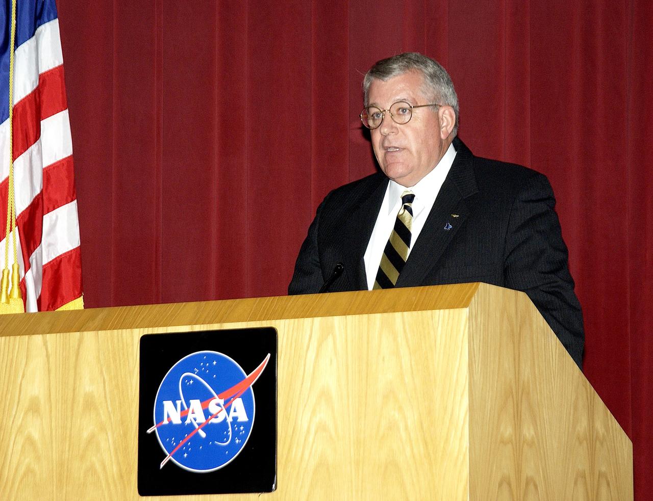 KENNEDY SPACE CENTER, FLA. -  Bill Pickavance, vice president and deputy program manager, Florida operations, United Space Alliance, speaks to employees during Center Director Jim Kennedy’s first all-hands meeting for employees.  Also on the agenda was Dr. Woodrow Whitlow Jr., KSC deputy director, and Tim Wilson, assistant chief engineer for Shuttle.  Representatives from the Shuttle program and contractor team were on hand to discuss the Columbia Accident Investigation Board report and where KSC stands in its progress toward return to flight.
