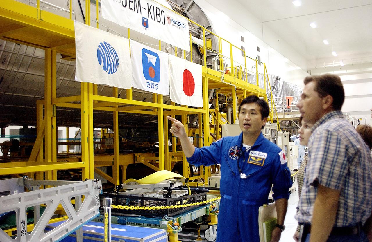 KENNEDY SPACE CENTER, FLA. - In the Space Station Processing Facility, Japanese astronaut Koichi Wakata looks over the Pressurized Module, or PM, part of the Japanese Experiment Module (JEM).  The PM provides a shirt-sleeve environment in which astronauts on the International Space Station can conduct microgravity experiments. There are a total of 23 racks, including 10 experiment racks, inside the PM providing a power supply, communications, air conditioning, hardware cooling, water control and experiment support functions.