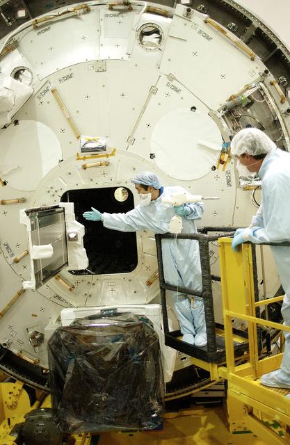 NASA image: KENNEDY SPACE CENTER, FLA. -   Japanese astronaut Koichi Wakata (left) releases a tray  extended from inside the Pressurized Module, or PM, that he was working with.  Part of the Japanese Experiment Module (JEM), the PM provides a shirt-sleeve environment in which astronauts on the International Space Station can conduct microgravity experiments. There are a total of 23 racks, including 10 experiment racks, inside the PM providing a power supply, communications, air conditioning, hardware cooling, water control and experiment support functions.  The JEM/PM is in the Space Station Processing Facility.