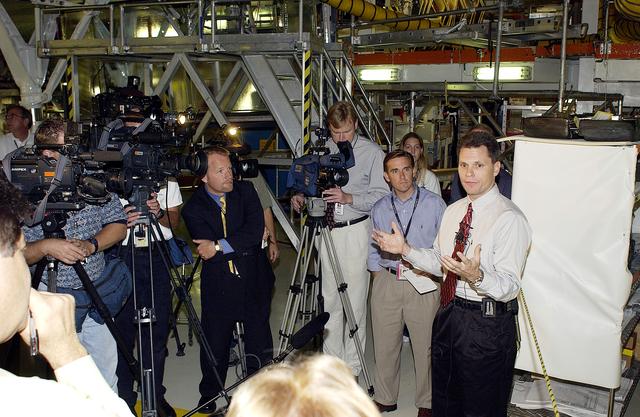 NASA image: KENNEDY SPACE CENTER, FLA. -   NASA Vehicle Manager Scott Thurston (right)  talks to the media in the Orbiter Processing Facility .  The media was invited to see the orbiter Atlantis as it is being prepared for Return to Flight.  Both local and national reporters representing print and TV networks were able to see work in progress on Atlantis, including the reinstallation of the Reinforced Carbon-Carbon panels on the orbiter’s wing leading edge; wiring inspections; and checks of the engines in the Orbital Maneuvering System.