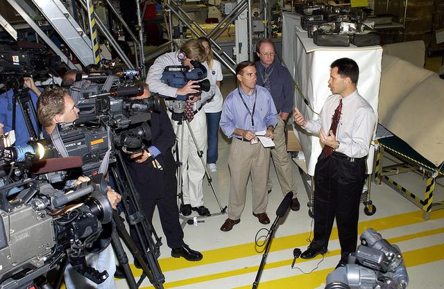NASA image: KENNEDY SPACE CENTER, FLA. -   NASA Vehicle Manager Scott Thurston (right)  talks to the media in the Orbiter Processing Facility.  The media was invited to see the orbiter Atlantis as it is being prepared for Return to Flight.  Both local and national reporters representing print and TV networks were able to see work in progress on Atlantis, including the reinstallation of the Reinforced Carbon-Carbon panels on the orbiter’s wing leading edge; wiring inspections; and checks of the engines in the Orbital Maneuvering System.  will be available to discuss the work and answer questions.